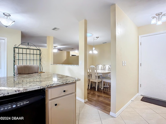 111 Grey Branch Rd, Port Orange, FL 32128 - kitchen with black dishwasher, ceiling fan, light tile patterned flooring, and light stone countertops