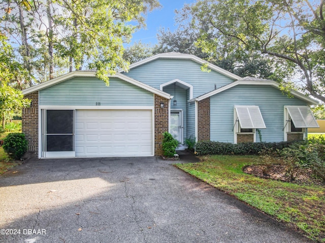 111 Grey Branch Rd, Port Orange, FL 32128 - single story home featuring brick siding, driveway, and a garage