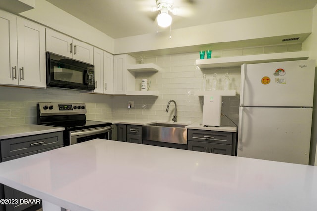 kitchen with white fridge, white cabinetry, gray cabinets, stainless steel electric range oven, and decorative backsplash