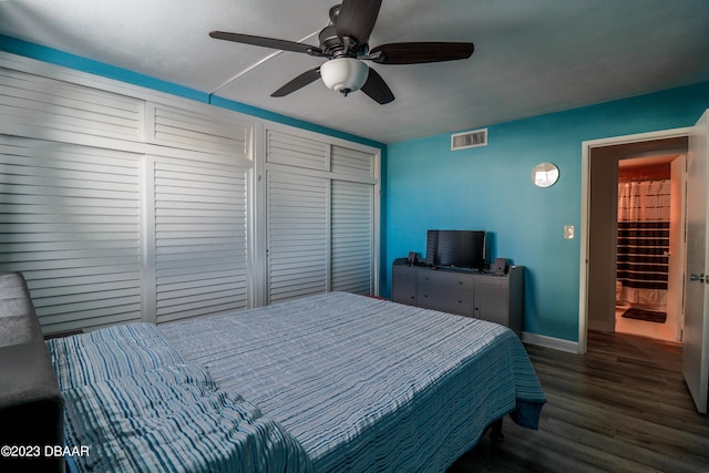 bedroom featuring dark hardwood / wood-style flooring, ceiling fan, and a closet