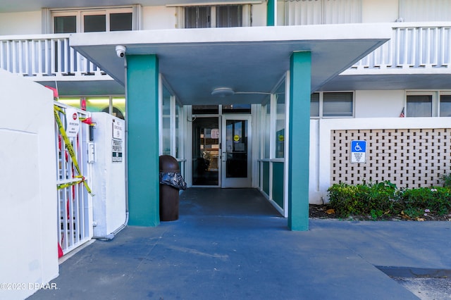 doorway to property featuring a balcony and a carport