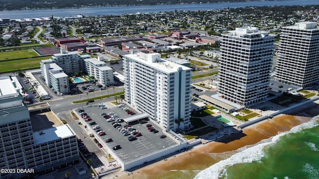 drone / aerial view featuring a water view and a beach view