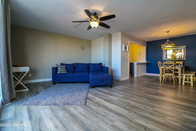 living room featuring hardwood / wood-style flooring and ceiling fan