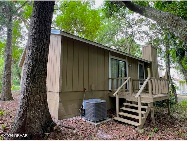 167 Fox Glen Ct, Ormond Beach, FL 32174 - rear view of house featuring central air condition unit and a wooden deck