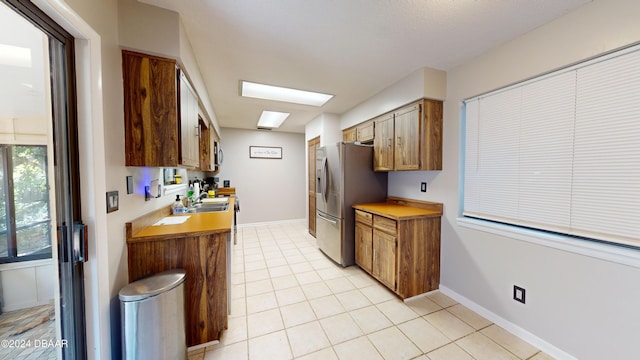 167 Fox Glen Ct, Ormond Beach, FL 32174 - kitchen featuring a skylight, appliances with stainless steel finishes, and light tile patterned flooring