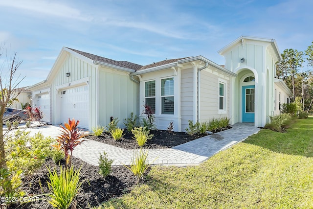 view of front facade with a front lawn and a garage