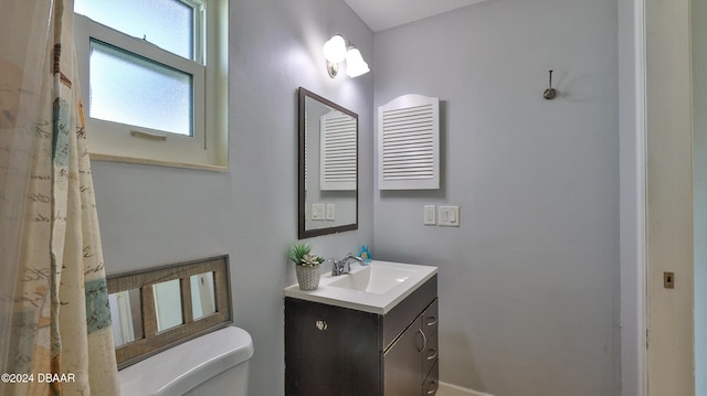 bathroom with toilet and vanity