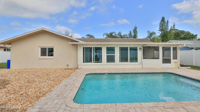 back of house with a sunroom and a patio