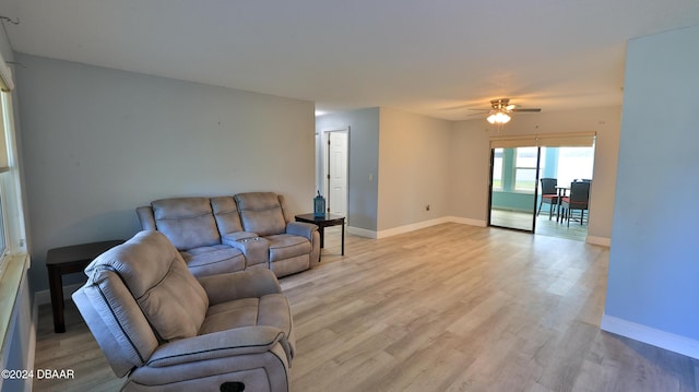 living room featuring ceiling fan and light hardwood / wood-style floors