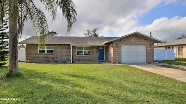 ranch-style home featuring brick siding, concrete driveway, an attached garage, fence, and a front yard