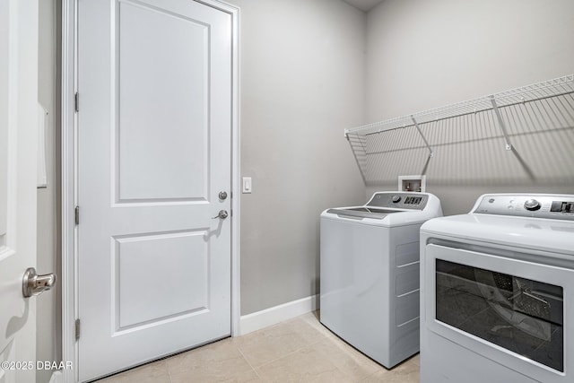 136 Longridge Ln, Ormond Beach, FL 32174 - laundry area with separate washer and dryer, baseboards, and light tile patterned floors