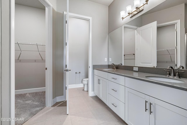 136 Longridge Ln, Ormond Beach, FL 32174 - full bath featuring double vanity, toilet, a spacious closet, and tile patterned floors