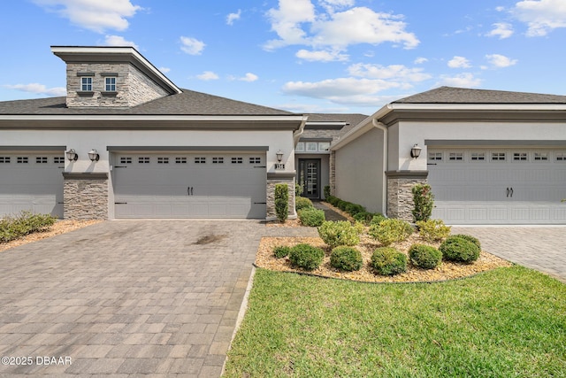 136 Longridge Ln, Ormond Beach, FL 32174 - view of front of property featuring stone siding, stucco siding, and decorative driveway