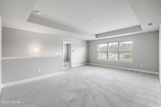 136 Longridge Ln, Ormond Beach, FL 32174 - empty room featuring a raised ceiling, carpet floors, baseboards, a textured ceiling, and a smoke detector