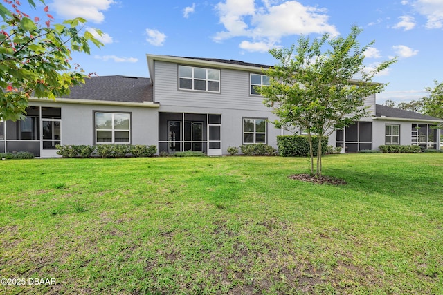 136 Longridge Ln, Ormond Beach, FL 32174 - back of property with a sunroom, a yard, stucco siding, and roof with shingles