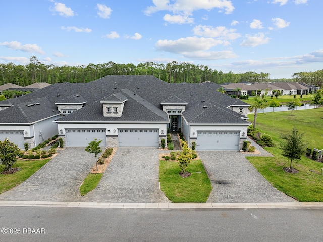 136 Longridge Ln, Ormond Beach, FL 32174 - view of front facade featuring a residential view, decorative driveway, a water view, and a garage