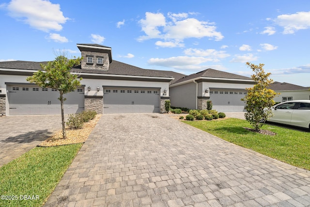 136 Longridge Ln, Ormond Beach, FL 32174 - prairie-style home featuring stone siding, stucco siding, and decorative driveway