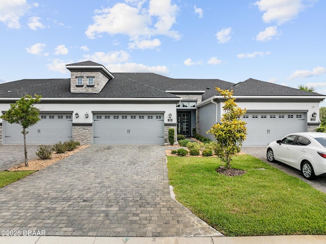136 Longridge Ln, Ormond Beach, FL 32174 - prairie-style house featuring stucco siding, a front yard, decorative driveway, and an attached garage