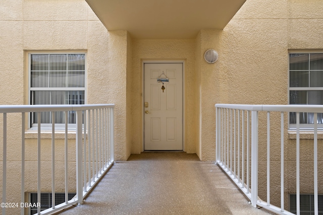 view of exterior entry featuring a balcony