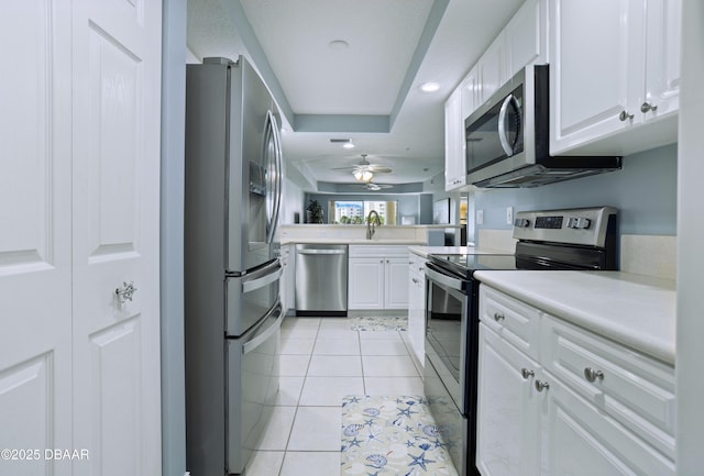 kitchen featuring white cabinets, ceiling fan, light tile patterned flooring, and appliances with stainless steel finishes