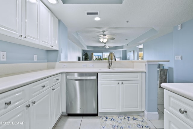 kitchen with kitchen peninsula, dishwasher, white cabinets, and light tile patterned floors