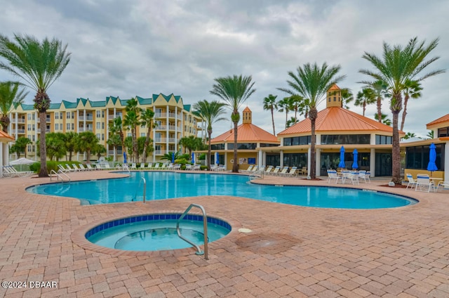 view of swimming pool with a gazebo, a community hot tub, and a patio