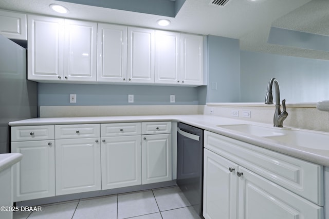 kitchen featuring stainless steel dishwasher, white cabinetry, sink, and light tile patterned floors