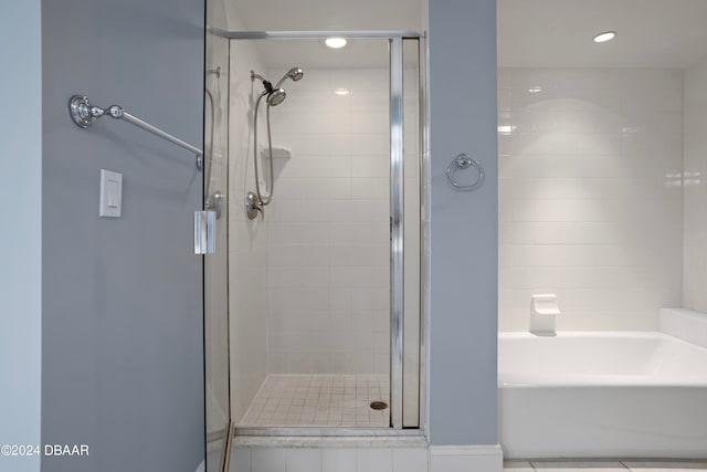 bathroom featuring a shower with shower door