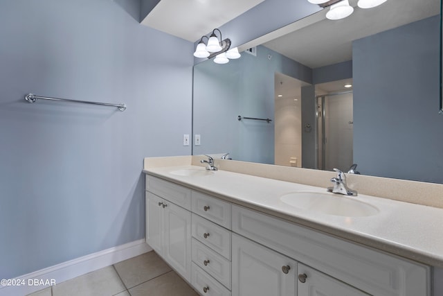 bathroom with tile patterned floors, vanity, and a shower with shower door