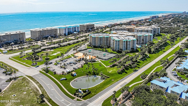 drone / aerial view featuring a view of the beach and a water view