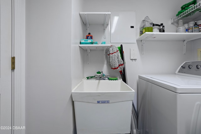 clothes washing area with sink and independent washer and dryer