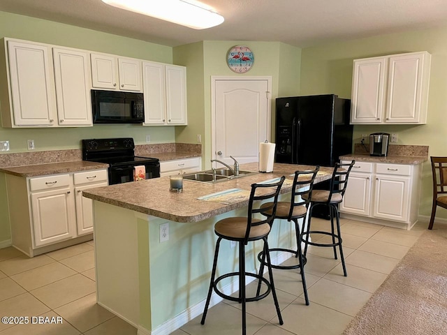 119 Fishermans Cove Dr, Edgewater, FL 32141 - kitchen with black appliances, a sink, white cabinetry, and light tile patterned floors