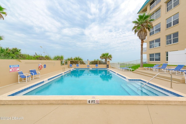 view of swimming pool featuring a patio