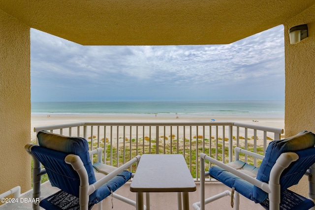 balcony with a water view and a beach view