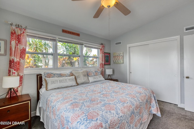 carpeted bedroom featuring ceiling fan, a closet, and lofted ceiling