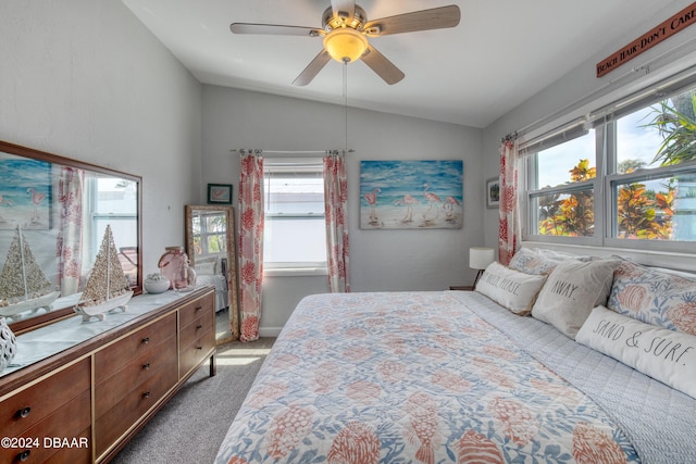 carpeted bedroom featuring multiple windows, lofted ceiling, and ceiling fan