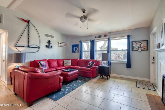 tiled living room featuring a fireplace, vaulted ceiling, and ceiling fan