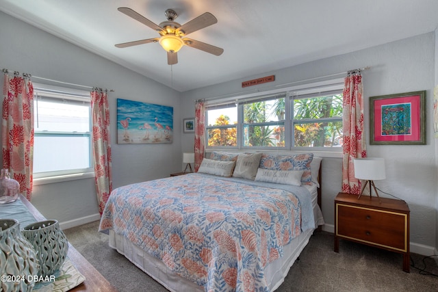 carpeted bedroom with multiple windows, ceiling fan, and lofted ceiling