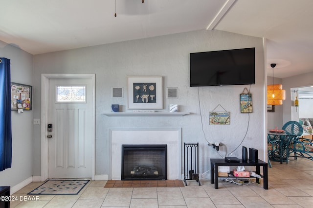 tiled living room featuring vaulted ceiling with beams and a fireplace