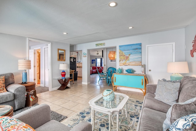 tiled living room featuring a textured ceiling