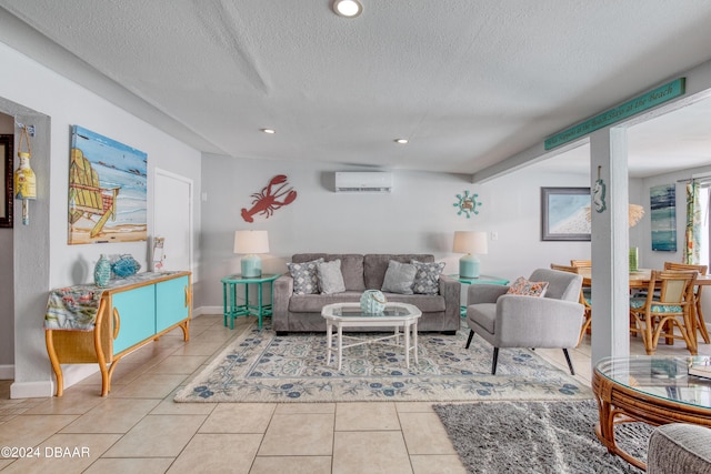 living room with a wall mounted AC, light tile patterned flooring, and a textured ceiling