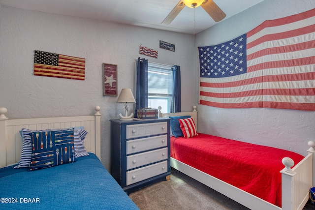 bedroom featuring dark colored carpet and ceiling fan