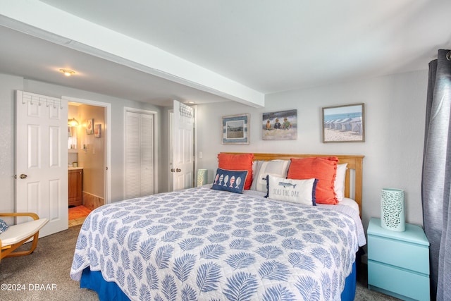 bedroom with ensuite bathroom, beam ceiling, and carpet floors