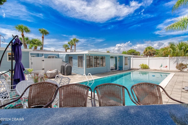 view of swimming pool with a patio and grilling area