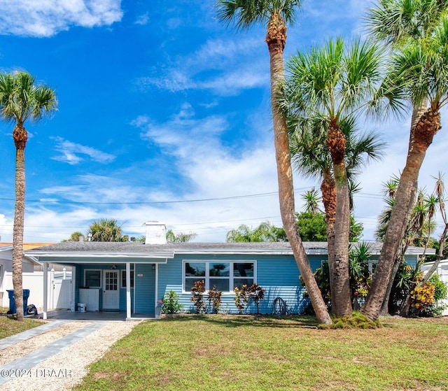 single story home with a front yard and a carport