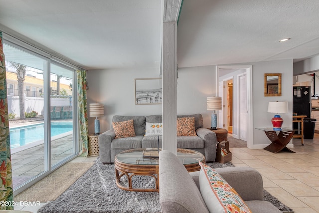 tiled living room featuring a textured ceiling