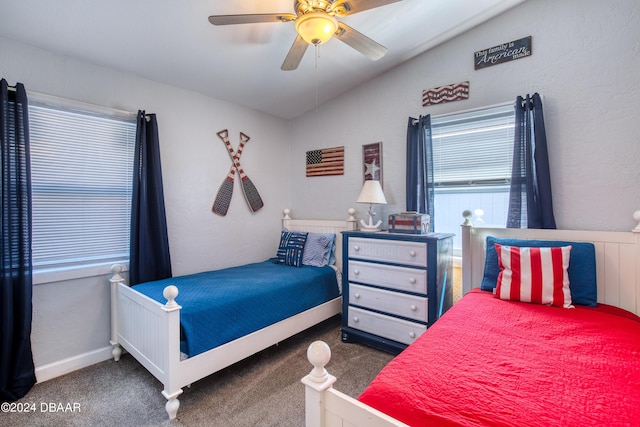 carpeted bedroom with ceiling fan and vaulted ceiling