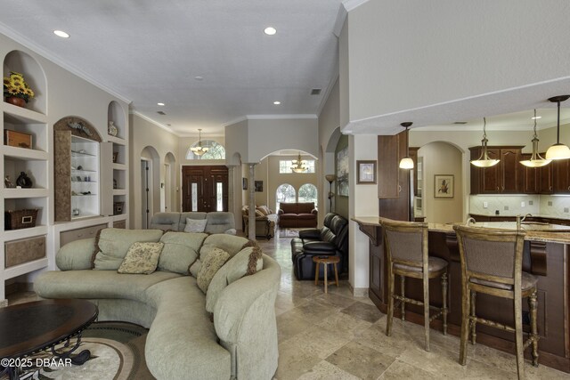 3 Indian Springs Dr, Ormond Beach, FL 32174 - living area featuring arched walkways, ornamental molding, built in features, recessed lighting, and a chandelier