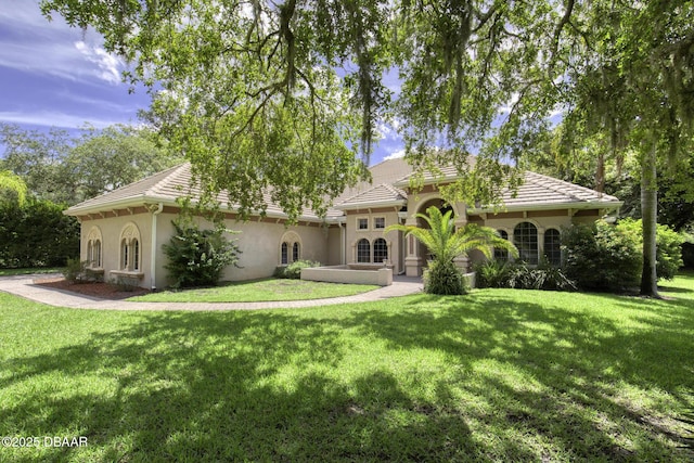 3 Indian Springs Dr, Ormond Beach, FL 32174 - view of front of home with stucco siding, a front lawn, and a tile roof
