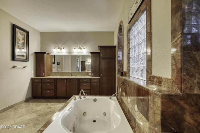 3 Indian Springs Dr, Ormond Beach, FL 32174 - bathroom with vanity, a tub with jets, and a textured ceiling